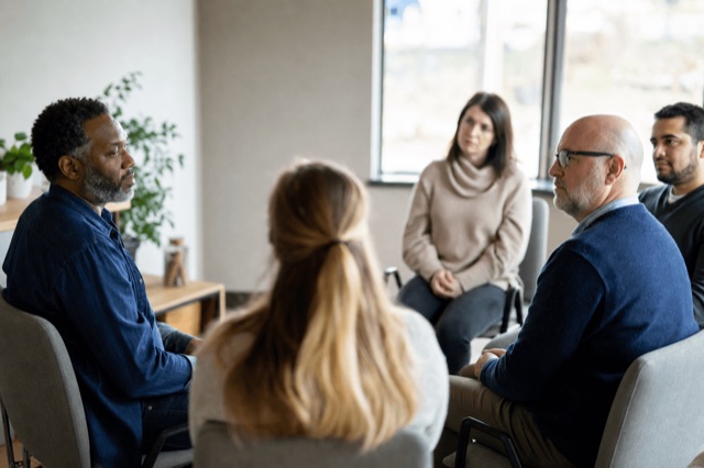 A quiet outpatient therapy office with chairs arranged for a small group session and natural light from a window
