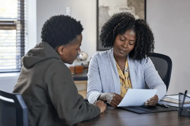 A person and an admissions counselor reviewing treatment options together at a desk in a calm office